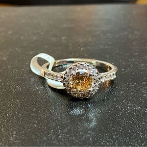 Topaz stone with small white stones on a sterling silver band size 9